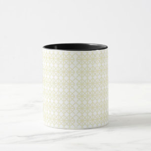 a white and gold geometric pattern mug
