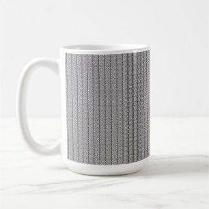 A white and grey geometric pattern fills the image coffee mug