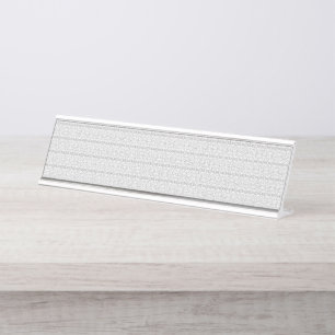 A white and grey geometric pattern fills the image desk name plate