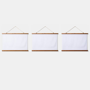 A white and yellow patterned rug is layered with p hanging tapestry