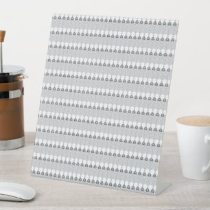 a white background with a pattern of circles pedestal sign