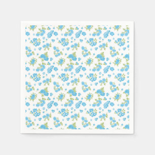 a white background with blue flowers and green lea napkin