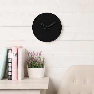 A white clock displayed prominently against a soli