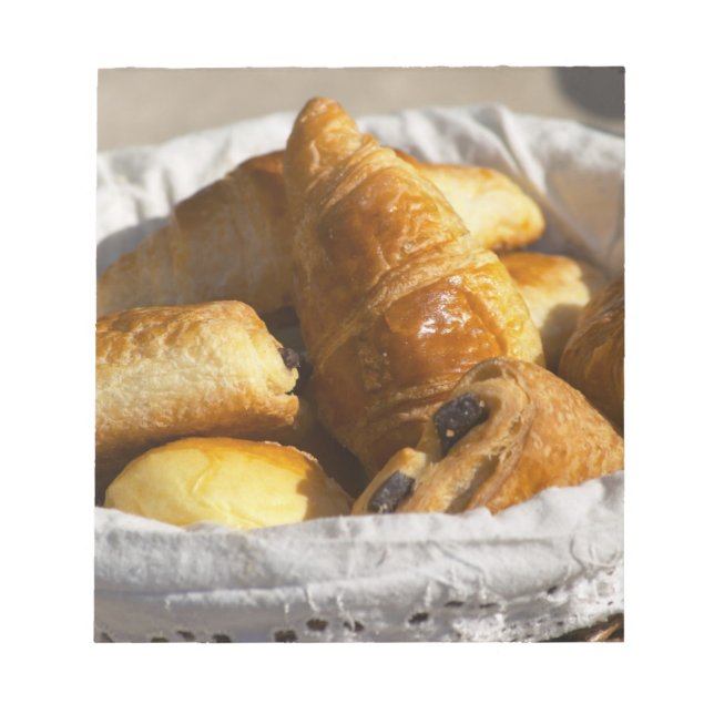 A wicker breakfast basket with croissants, and notepad (Front)