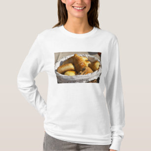 A wicker breakfast basket with croissants, and T-Shirt