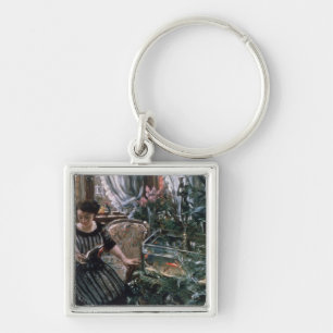 A Woman Reading near a Goldfish Tank Key Ring