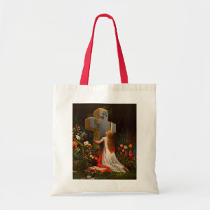 A woman with a cross is praying tote bag