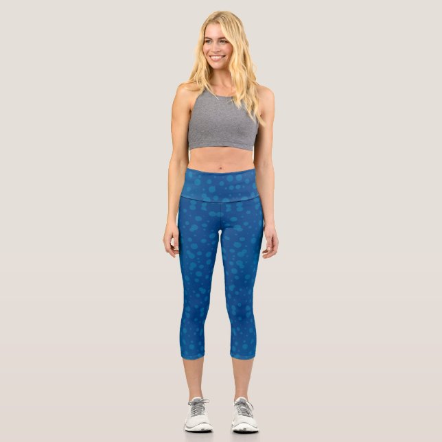 A woman's torso and legs in blue capri leggings  (Front)