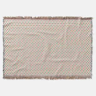 A woven blanket with a red and green polka dot