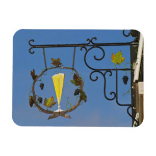 A wrought iron sign that illustrates the theme magnet