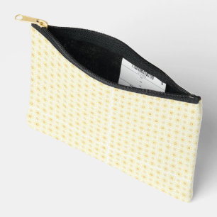 a yellow and white background with small circles accessory pouch