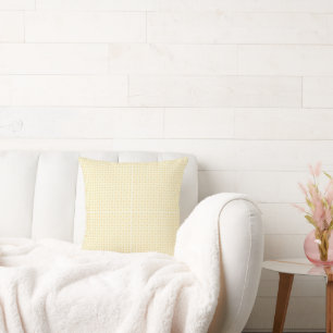 a yellow and white background with small circles cushion