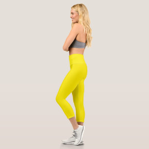 a yellow background with a black border capri leggings