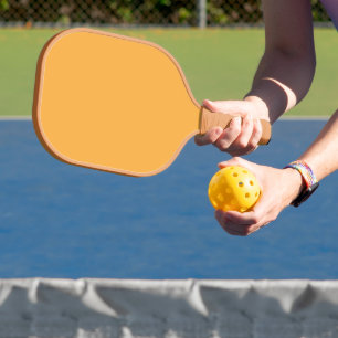 a yellow background with a black border pickleball paddle