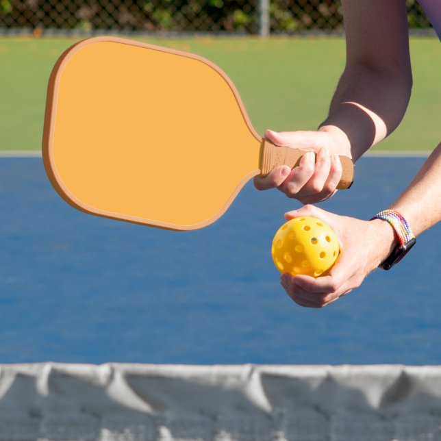 a yellow background with a black border pickleball paddle (Insitu)