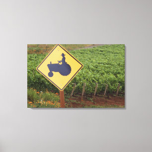 A yellow tractor crossing sign in the vineyard