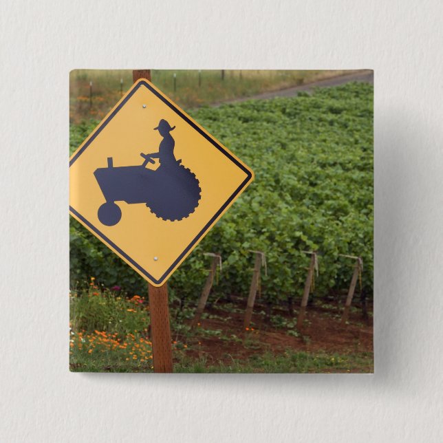 A yellow tractor crossing sign in the vineyard 15 cm square badge (Front)