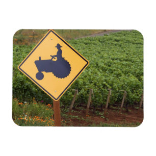 A yellow tractor crossing sign in the vineyard magnet