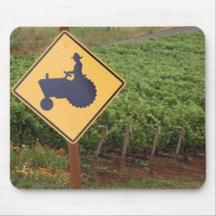 A yellow tractor crossing sign in the vineyard mouse mat