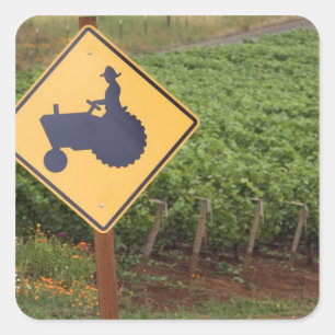A yellow tractor crossing sign in the vineyard square sticker