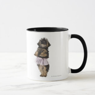 A Yorkie-poo puppy in a tutu on her hind legs. Mug