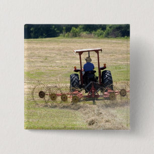 A young boy driving a tractor harvesting 15 cm square badge