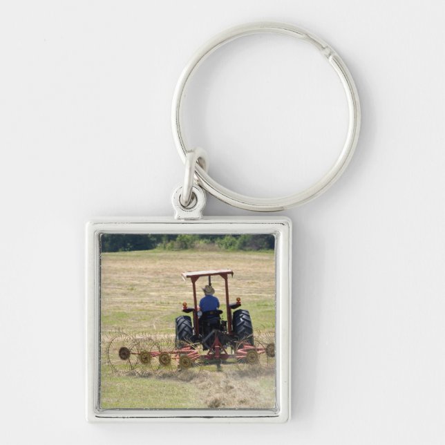 A young boy driving a tractor harvesting key ring (Front)