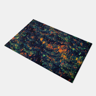 Abstract mosaic of displaced campfire on greenish doormat