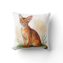 Abyssinian cat surrounded by soft colours and gree