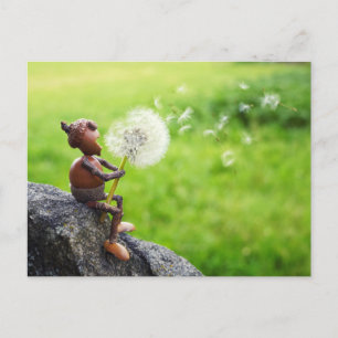 Acorn elf blows into dandelion postcard