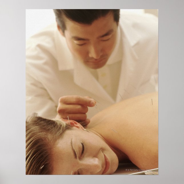 Acupuncturist putting needles in woman's back poster (Front)