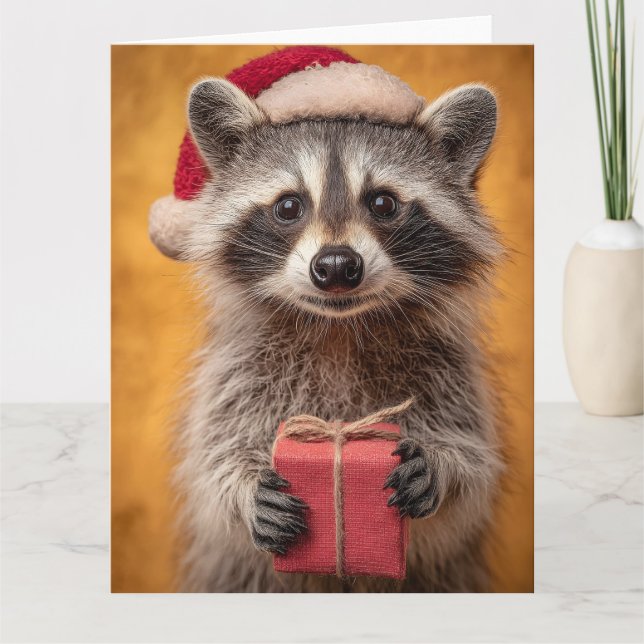 Adorable Raccoon in a Santa Hat Holding a Present Card (Front)