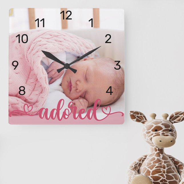 Adored Baby Girl Photo Pink Nursery Square Wall Clock (New baby photo clock for the nursery lettered with "adored" and decorated with love hearts)