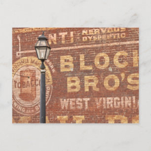 Advertisements on side of building postcard