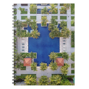 Aerial view of pool surrounded by palm trees notebook