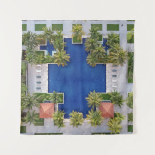 Aerial view of pool surrounded by palm trees tapestry