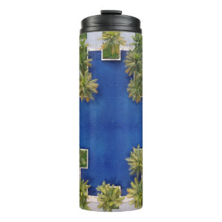 Aerial view of pool surrounded by palm trees thermal tumbler