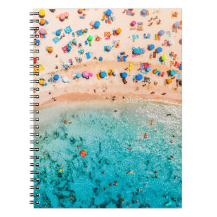 Aerial view of sandy beach with colourful umbrella notebook