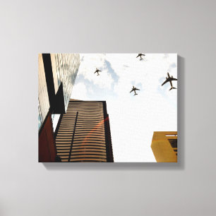 Aeroplanes flying over buildings canvas print