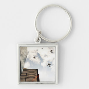 Aeroplanes flying over buildings key ring