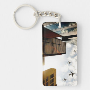 Aeroplanes flying over buildings key ring