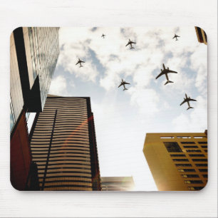 Aeroplanes flying over buildings mouse mat