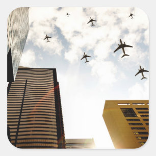 Aeroplanes flying over buildings square sticker