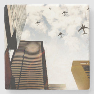 Aeroplanes flying over buildings stone coaster