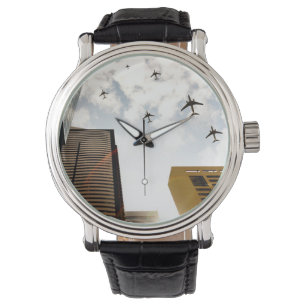 Aeroplanes flying over buildings watch