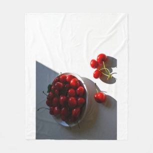 Aesthetic still life with ripe cherries on a white fleece blanket
