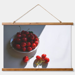 Aesthetic still life with ripe cherries on a white hanging tapestry