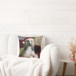 Afghan Hound Wearing a Santa Claus Hat Cushion<br><div class="desc">A beautiful Afghan hound dog with long,  silky fur lounges on a red velvet couch,  wearing a festive Santa hat</div>