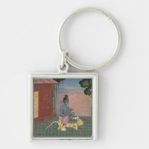 Aged ascetic seated on a tiger skin outside a buil key ring