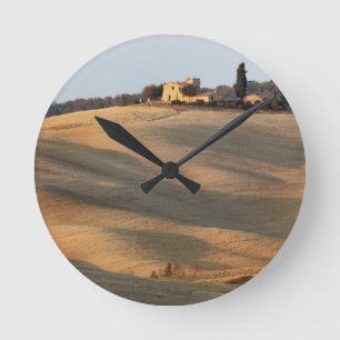 Agricultural field at sunset, Val d'Orcia, Tusca Round Clock